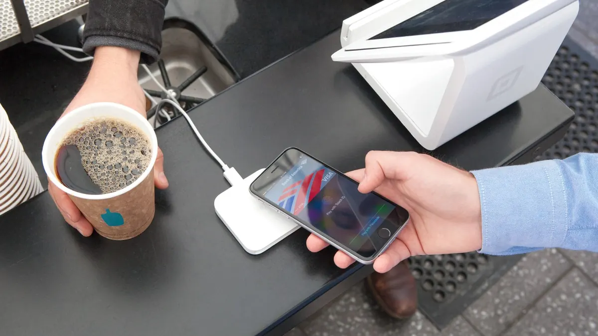 Contactless iPhone payment at a San Francisco café in 2015; archive image, not the UK regulatory consultation.
